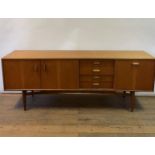 A G-Plan teak sideboard, having three doors and four drawers, 210 cm wide