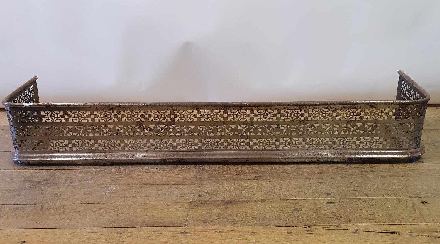 A 19th century cast iron fender, with pierced decoration, 134 cm wide