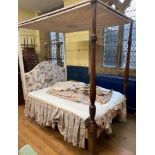 A George III style mahogany four poster bed, on octagonal baluster ends with leaf carved and