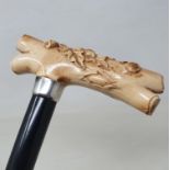 An early 20th century walking stick, with carved ivory handle, in the form of an oak branch with
