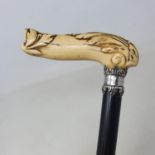 A walking stick, with a carved ivory handle, on ebony shaft, 85 cm