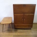 An Ercol light elm cocktail cabinet, having a fall front, two cupboard doors and a drawer, 83 cm
