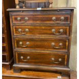 An oak chest of drawers, having a brushing slide and four graduated drawers on bracket feet, 66 cm