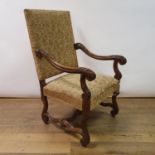 An 18th century style walnut armchair, with a padded back, seat and carved scroll arms, 114 cm high
