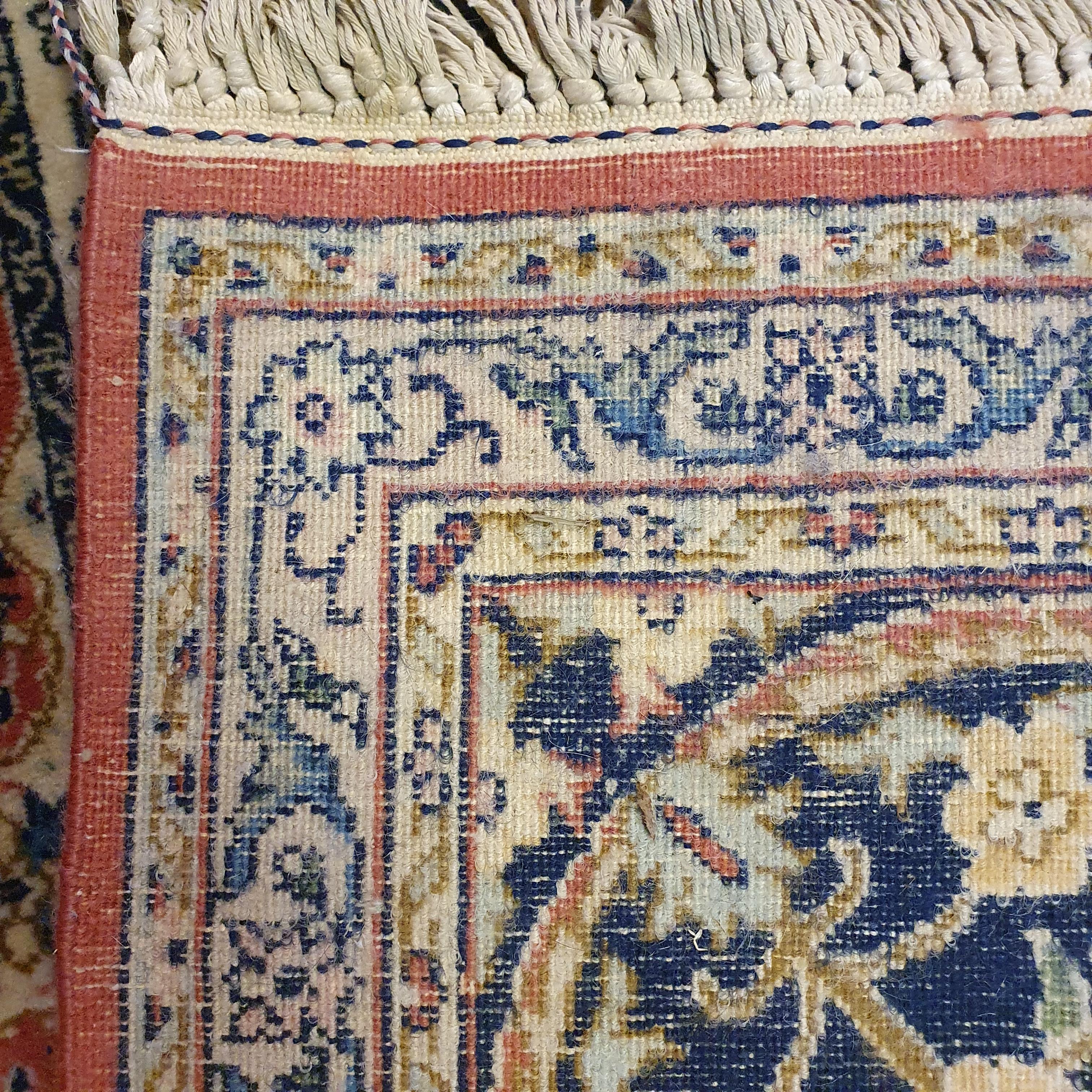 A Persian cream ground carpet, with a main blue border, centre with repeating square medallions, 340 - Image 2 of 2