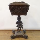 A 19th century oak teapoy, on a figural column support and a shaped base with lion's head feet, 85