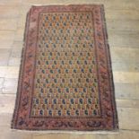 A Persian cream ground rug, main red border, centre with repeating medallions, 143 x 92 cm
