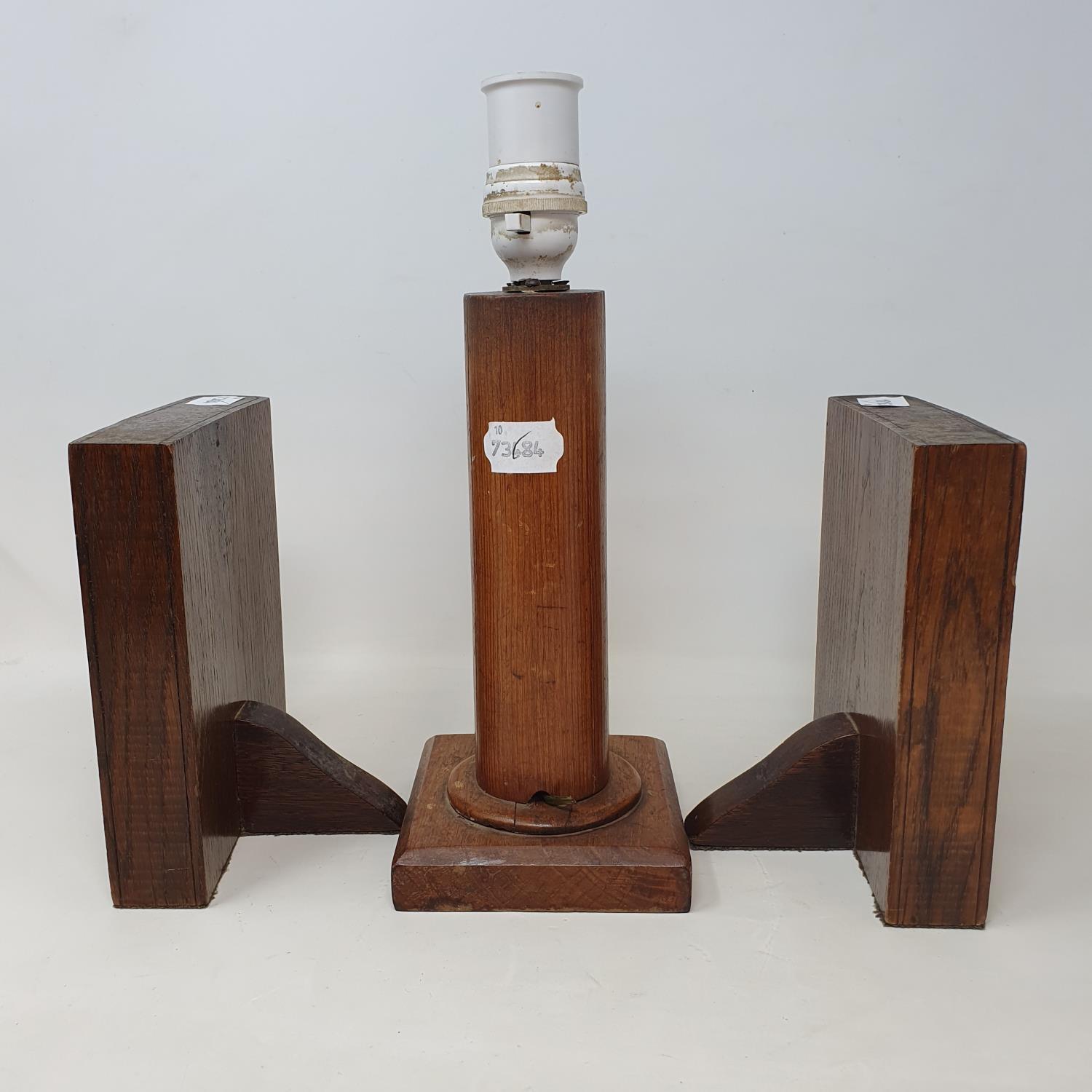 An early 20th century oak lamp base, painted with a crest, 24 cm, and a pair of similar bookends, in - Image 2 of 3