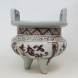 A Chinese red and white cauldron, with two handles, 12 cm diameter