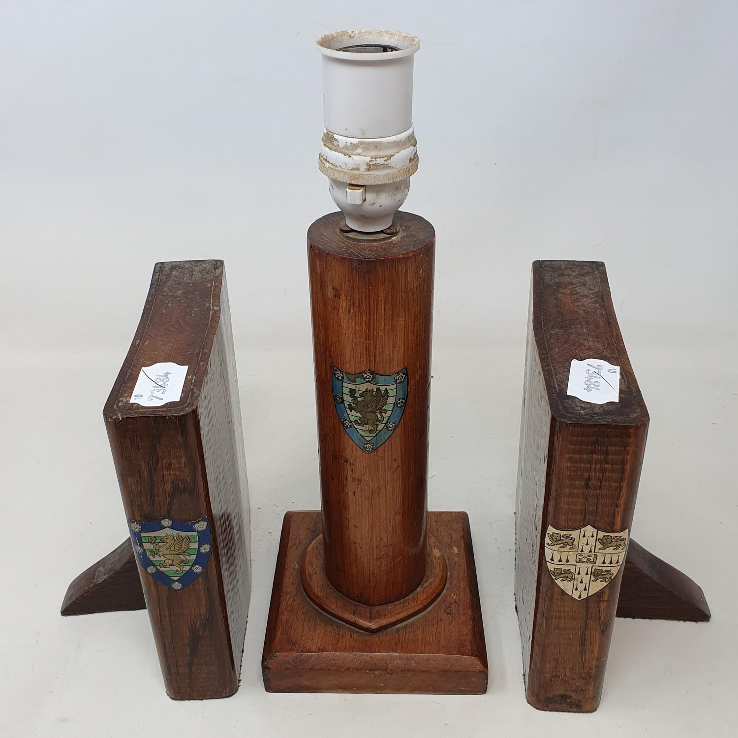 An early 20th century oak lamp base, painted with a crest, 24 cm, and a pair of similar bookends, in - Image 3 of 3