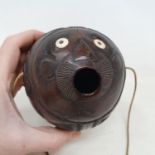 A carved coconut bugbear flask, 14 cm wide