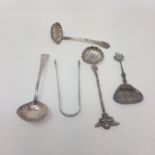 A pair of Victorian silver sugar tongs, a George III Old English pattern ladle, a Dutch silver