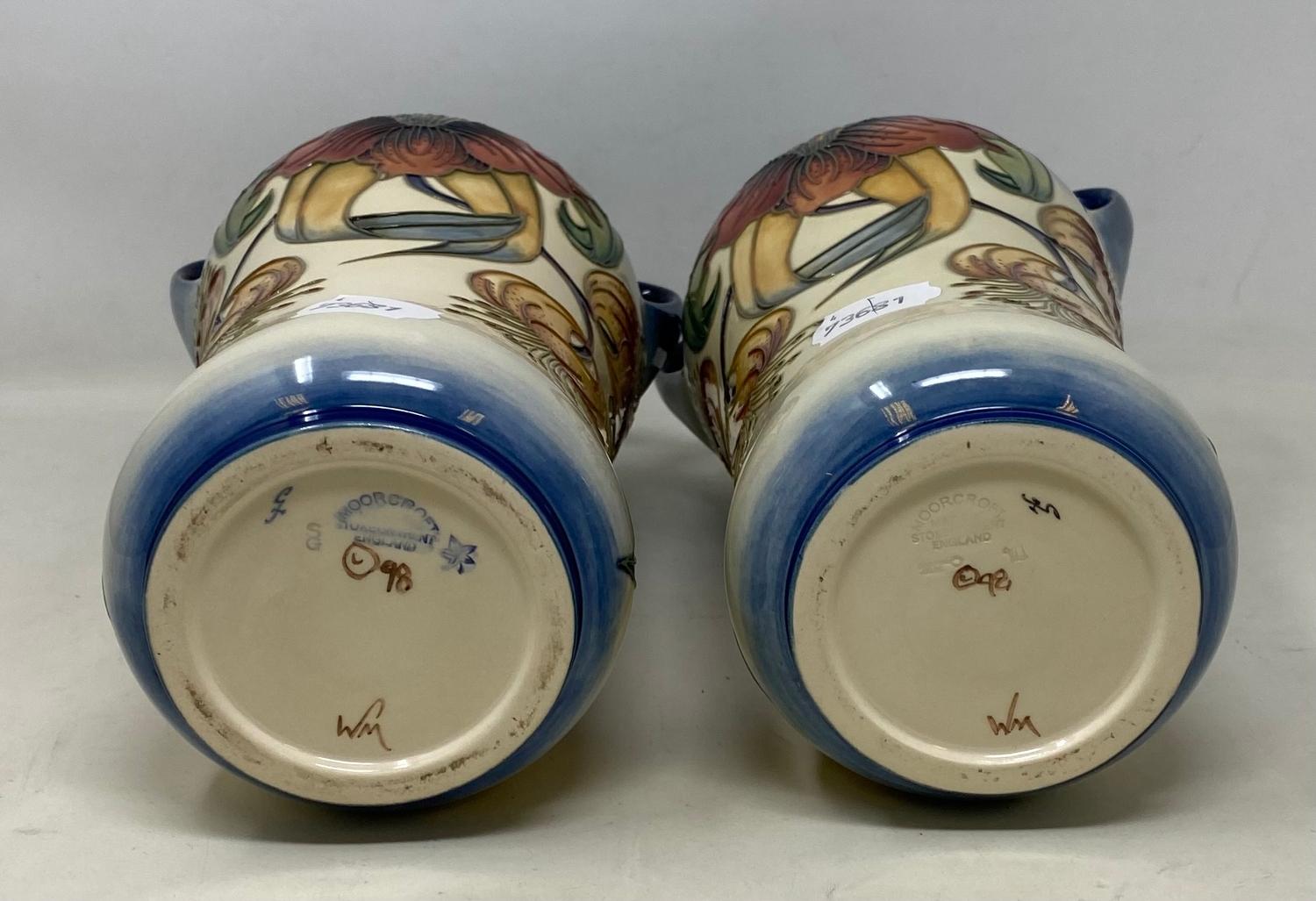 A pair of Moorcroft pottery vases, decorated flowers, with two handles and of waisted form, 25.5 - Image 3 of 4