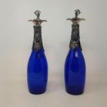 A pair of modern blue glass and decanters, with grape and vine plated mounts, 34 cm high (2)