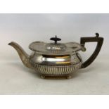 A silver teapot, with a reeded lower body, London 1906, 25.6 ozt (all in) 14 cm high