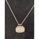 A diamond set pendant, in the form of a handbag, on a chain