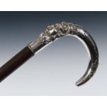 A 19th century Continental walking cane, with a silver coloured metal handle, decorated a devil's