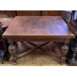 An oak draw leaf dining table, on bulbous turned legs joined by an X stretcher, 214 cm wide