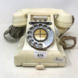 A white Bakelite spin dial telephone hand set with small glued chip to bottom speak in section, main