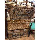 Three wicker laundry trunks, and three rugs (7) some worm to trunks, staining/loss to rugs