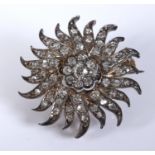 A late 19th/early 20th century diamond pendant/brooch, in the form of a flowerhead, 2.5 cm