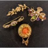A late Victorian yellow coloured metal and coral brooch, and three other brooches (4) coral brooch -
