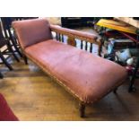A late Victorian oak chaise longue, on turned legs