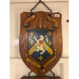 A set of three Caius School, Shoreham by Sea, house oak shield shape plaques, with painted emblems