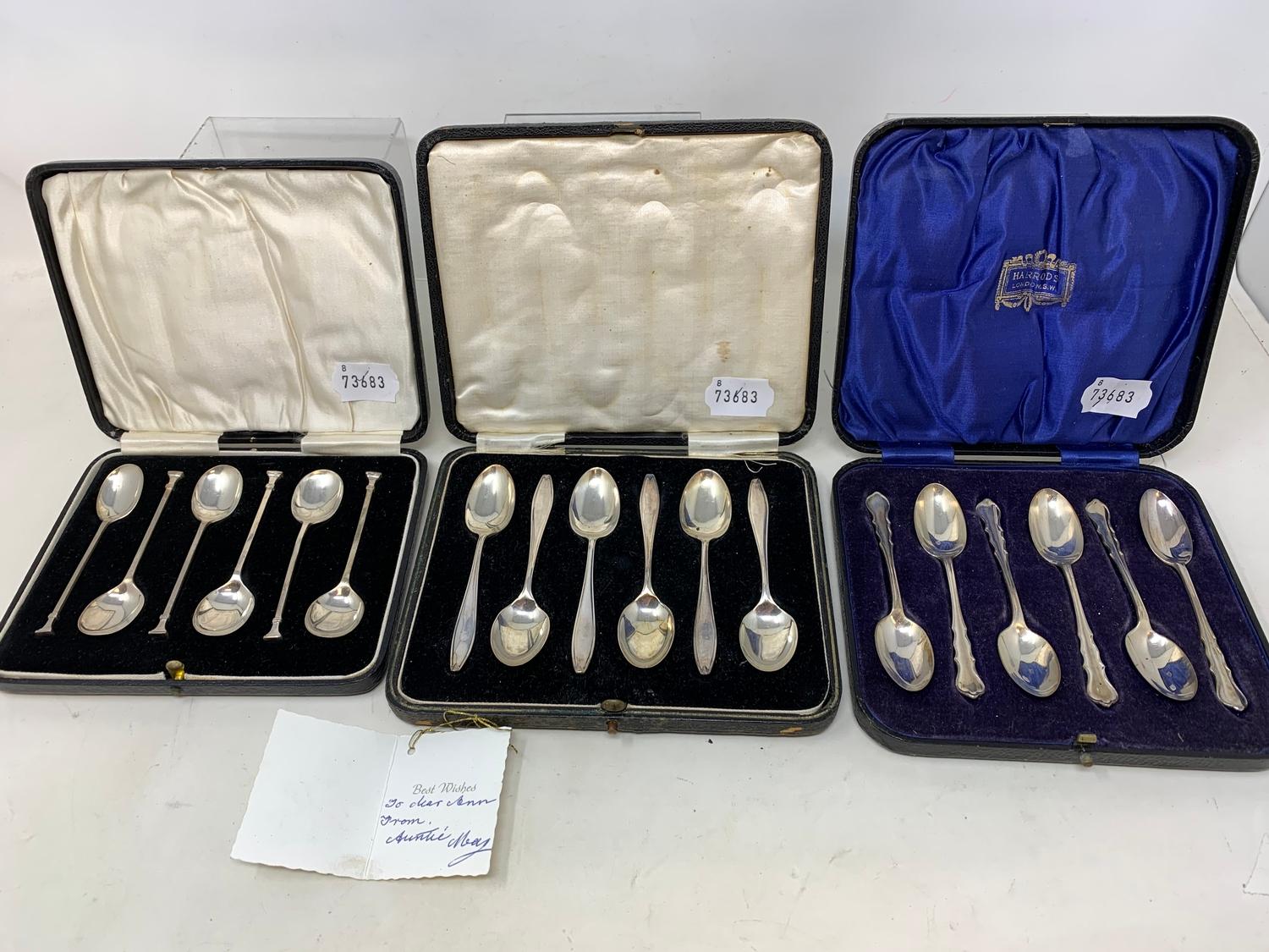 A set of six silver teaspoons, in a Harrods case, another set similar, and a set of six silver