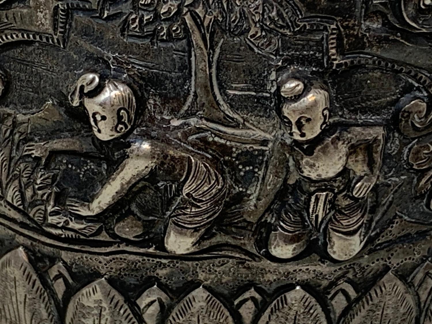 A Burmese silver coloured metal cylindrical box and cover, embossed figures, the base engraved a - Image 5 of 8