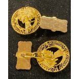 A pair of yellow coloured metal cufflinks, decorated palm trees Report by RB not marked and not