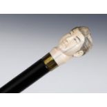 A 19th century walking stick, with a carved ivory handle, in the form of a Japanese man's head, on