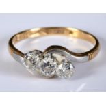 An 18ct gold and platinum three stone diamond ring, approx. ring size O½ Report by RB centre stone