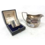 An early 19th century silver mug jug, probably London 1809, and a silver napkin ring, boxed, 5.2 ozt