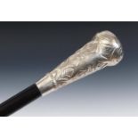 A walking cane, with a large silver coloured metal handle, decorated foliage, 91 cm