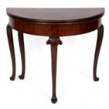 An 18th century mahogany D shaped tea table, on scroll carved cabriole legs with pad feet, 88 cm