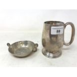 A silver mug, monogrammed and dated London 1930, 5.2 ozt, and a quaiche, 11 cm wide (2)