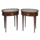 A pair of oval mahogany night stands, with a brass gallery, a frieze drawer, and on tapering