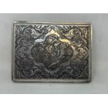 A Persian silver coloured metal cigarette case, decorated birds, flowers and foliage, 10.5 cm wide