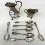 A silver cream jug, another, and eight silver teaspoons, 12.5 ozt