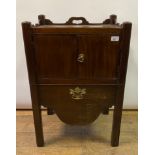 A 19th century mahogany tray top commode, having a pair of doors above a pull out drawer, 53.5 cm