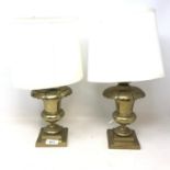 A pair of brass lamps, of urn form, on square bases, 20 cm high (excluding fitments)