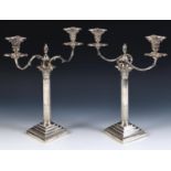 A pair of late Victorian silver Corinthian column table candelabra, with stepped square bases and