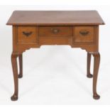 An oak lowboy, having three drawers above a shaped apron, on cabriole legs with pad feet, 82 cm wide