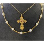 A yellow coloured metal filigree cross, on a chain, and a necklace, the clasp probably stamped