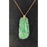 A Chinese carved mutton fat jade pendant, 4 cm high, on a chain