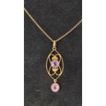 An Edwardian yellow coloured metal and amethyst pendant, on a 9ct gold chain Report by RB 6.3 g (all
