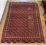 A red Bokhara carpet, 275 x 190 cm some wear, fringe mostly missing, 275 cm x 190 cm