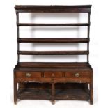 A 19th century oak dresser, the three tier plate rack above a base with three frieze drawers above a