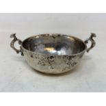 A Continental silver coloured metal two handle bowl, of hammered form, 13 cm wide RB Report Silghtly